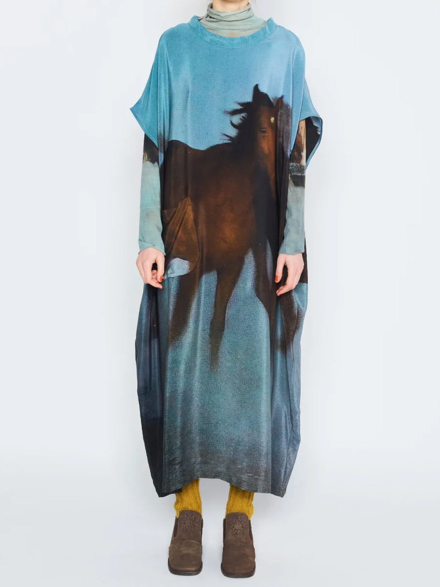Anntian Overdress in Print H worn from the front, showing the loose midi-length shape, short wide sleeves and all-over horse print.