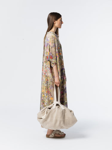 Side view of model wearing the Anntian Silk Dress in Print D, highlighting the relaxed silhouette, short sleeves, and draped neckline in a multicolour floral print silk