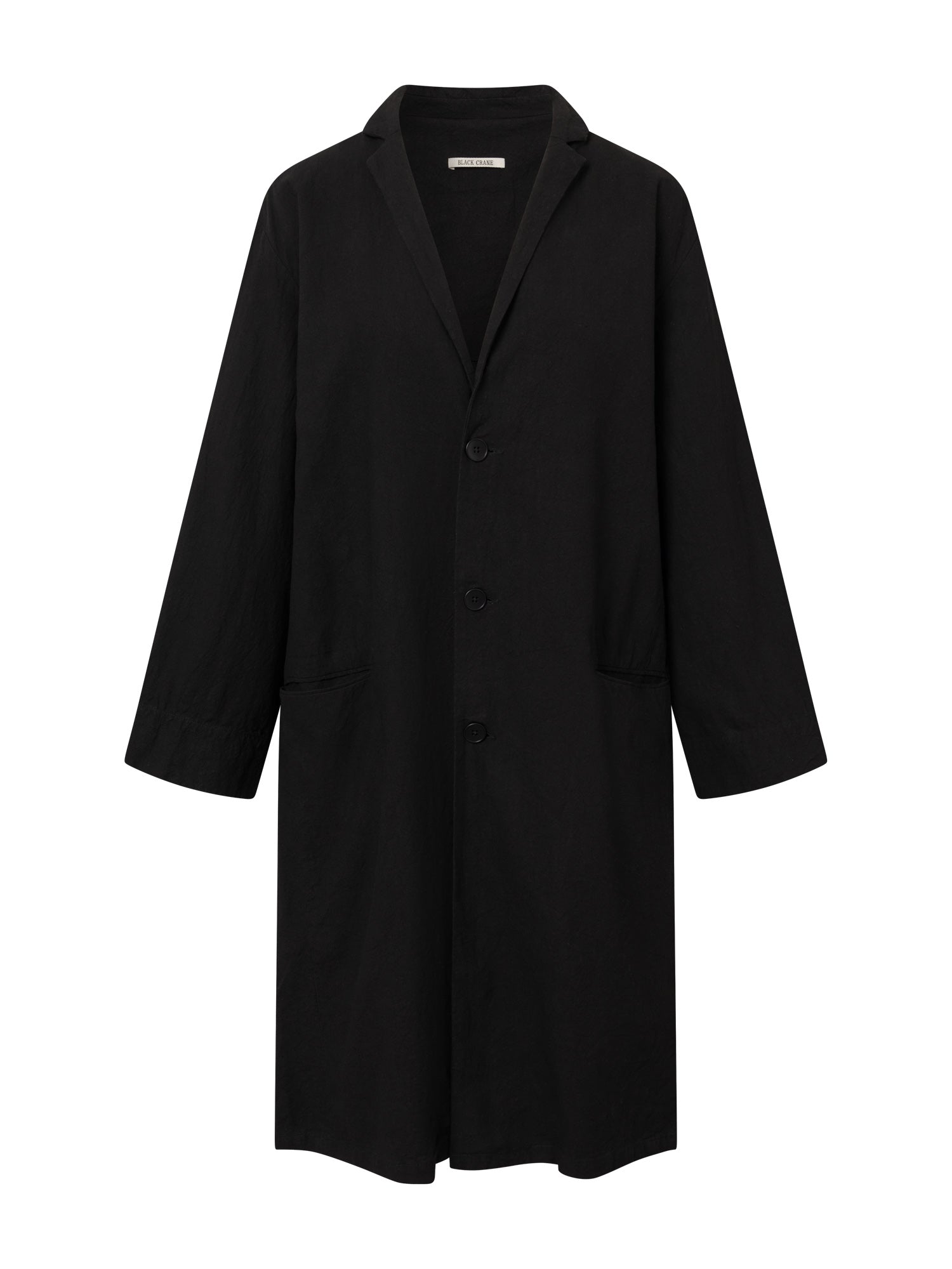 Front view of the Black Crane Crinkled Coat in black, featuring a wrinkled textured fabric, thin notch lapel, front button closure, long sleeves, and side pockets.