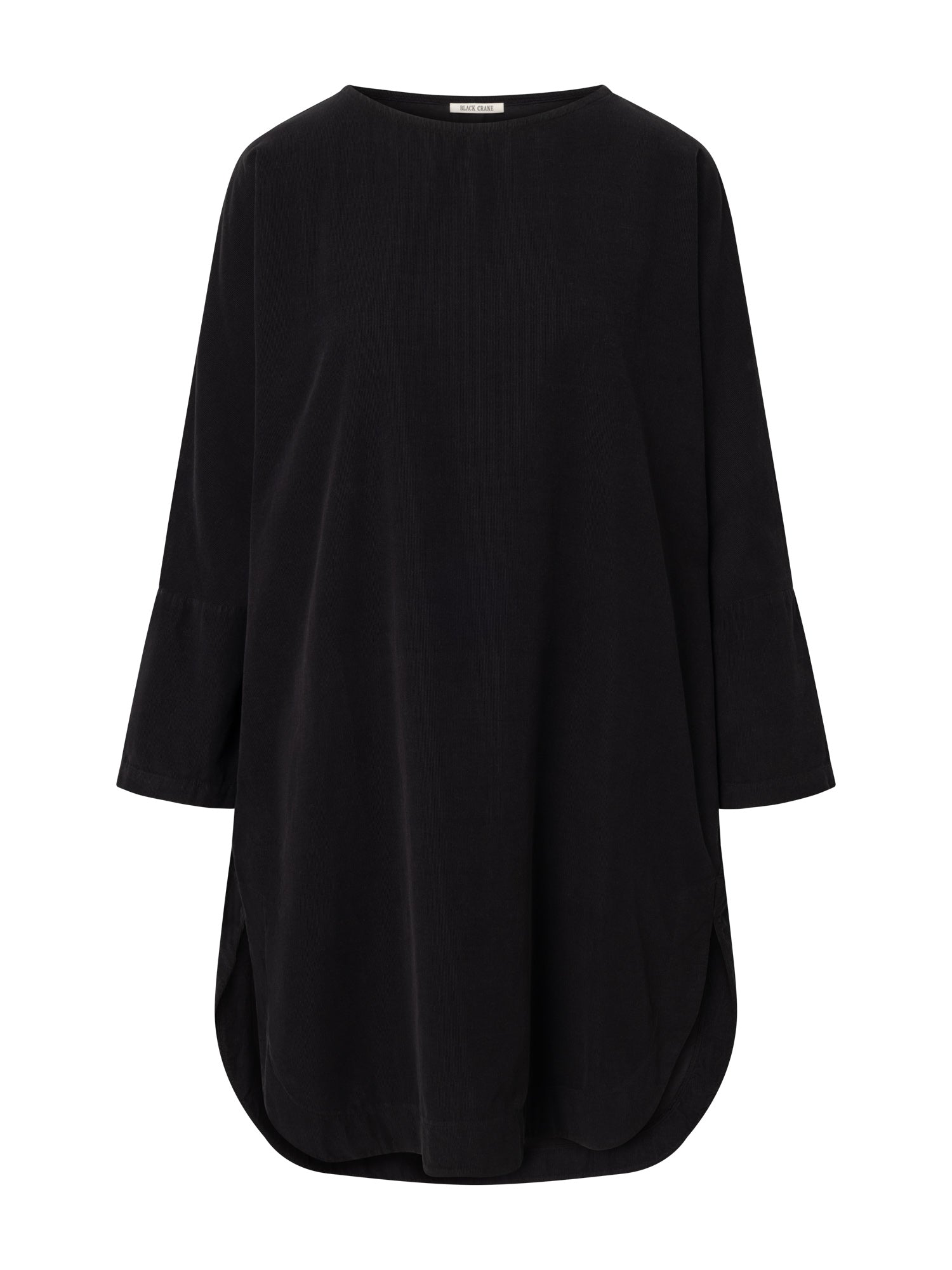 Front view of the Black Crane Painter Dress in dark navy corduroy, featuring a boat neckline, long sleeves, side pockets, a curved hem, and a side slit.