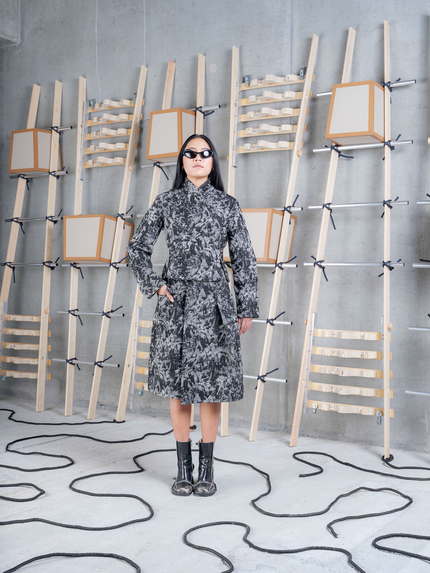 Model wearing Henrik Vibskov Carry Skirt in Black 3D White front three-quarter view
