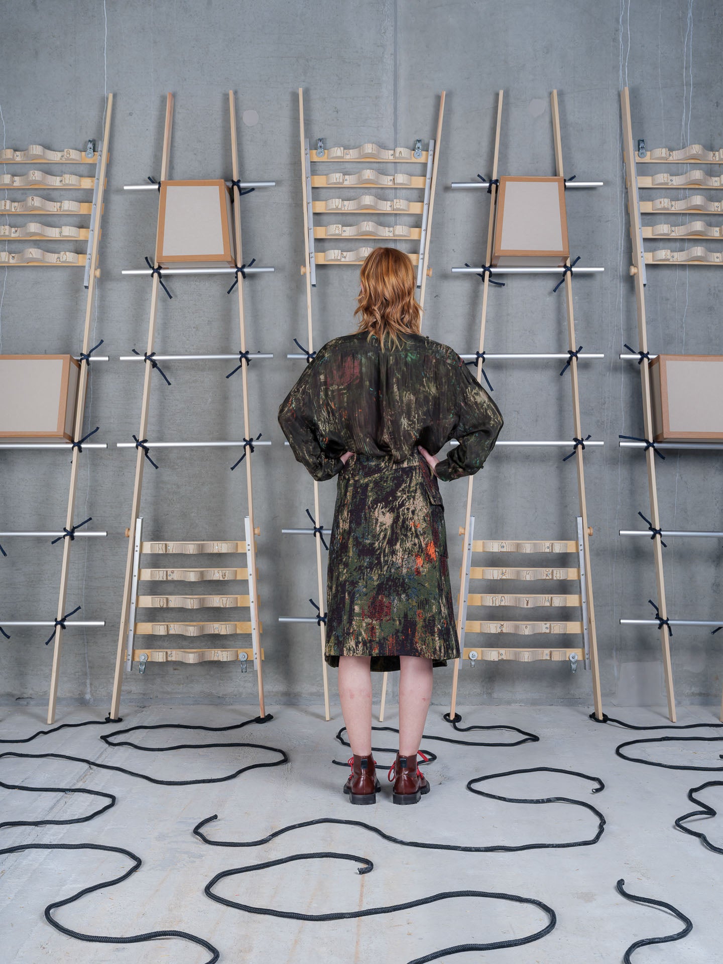 Model wearing Henrik Vibskov Carry Skirt in Gobelin Swamp rear three-quarter view
