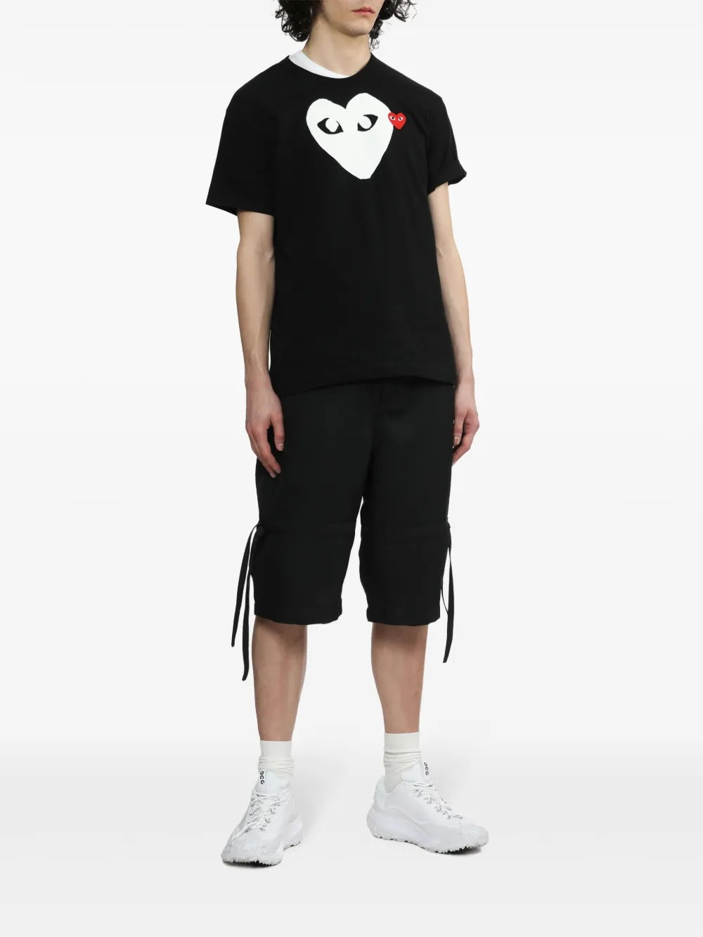 Model wearing Comme des Garçons Play Unisex Short Sleeve Big Heart T-Shirt in black with oversized white heart graphic and relaxed fit