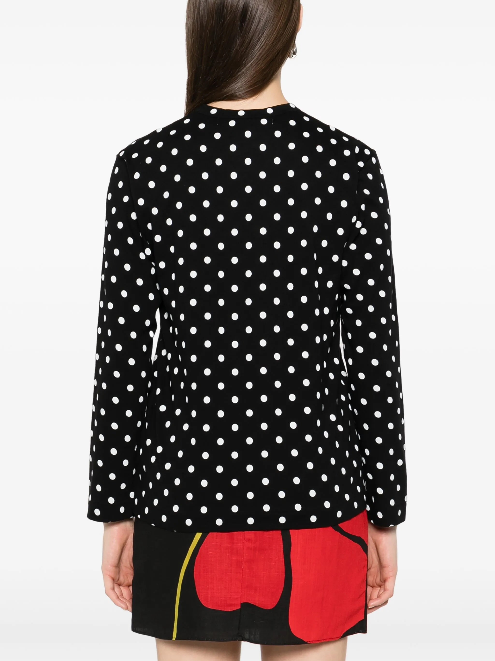 Back view of Comme des Garçons Play black polka dot long sleeve shirt showing all-over white dot print and straight hem