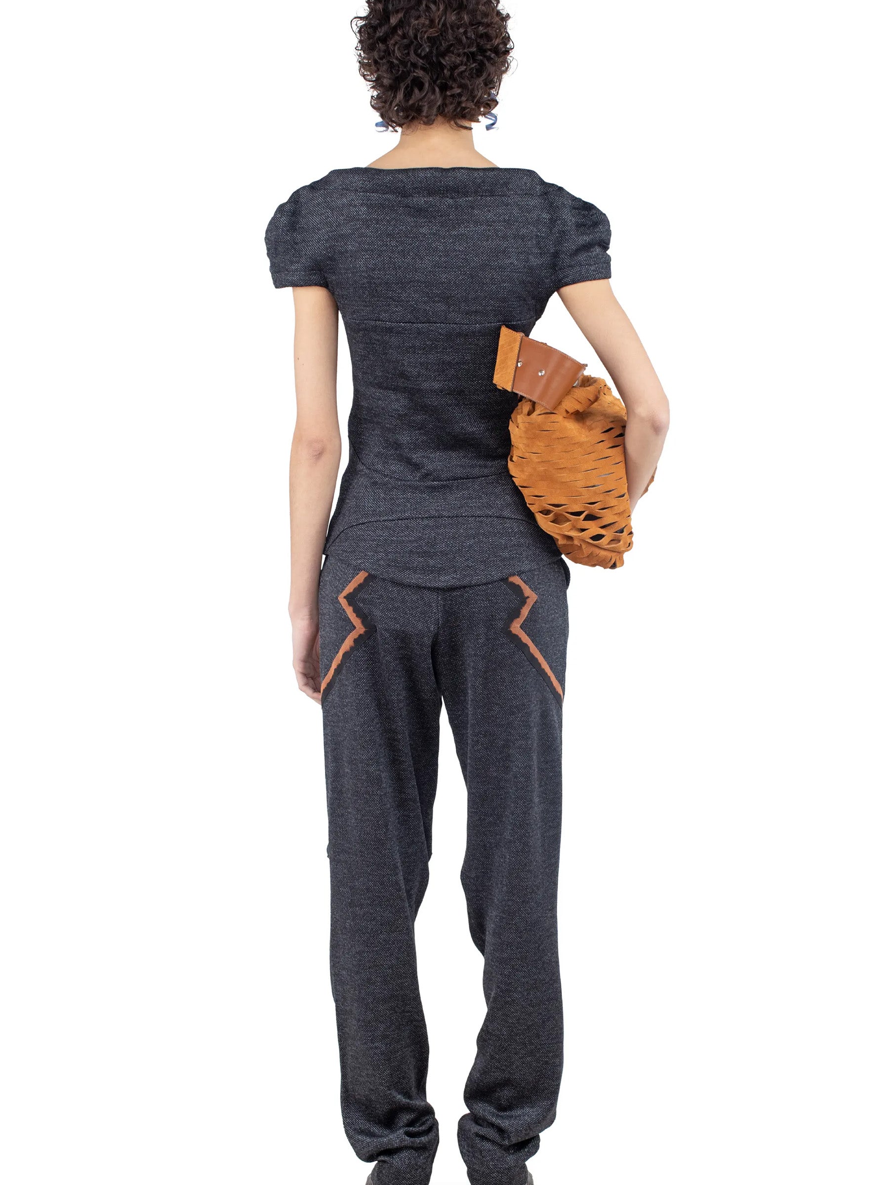 Rear view of the model wearing the Kiko Kostadinov Compass Jersey Top in Abyss Black.