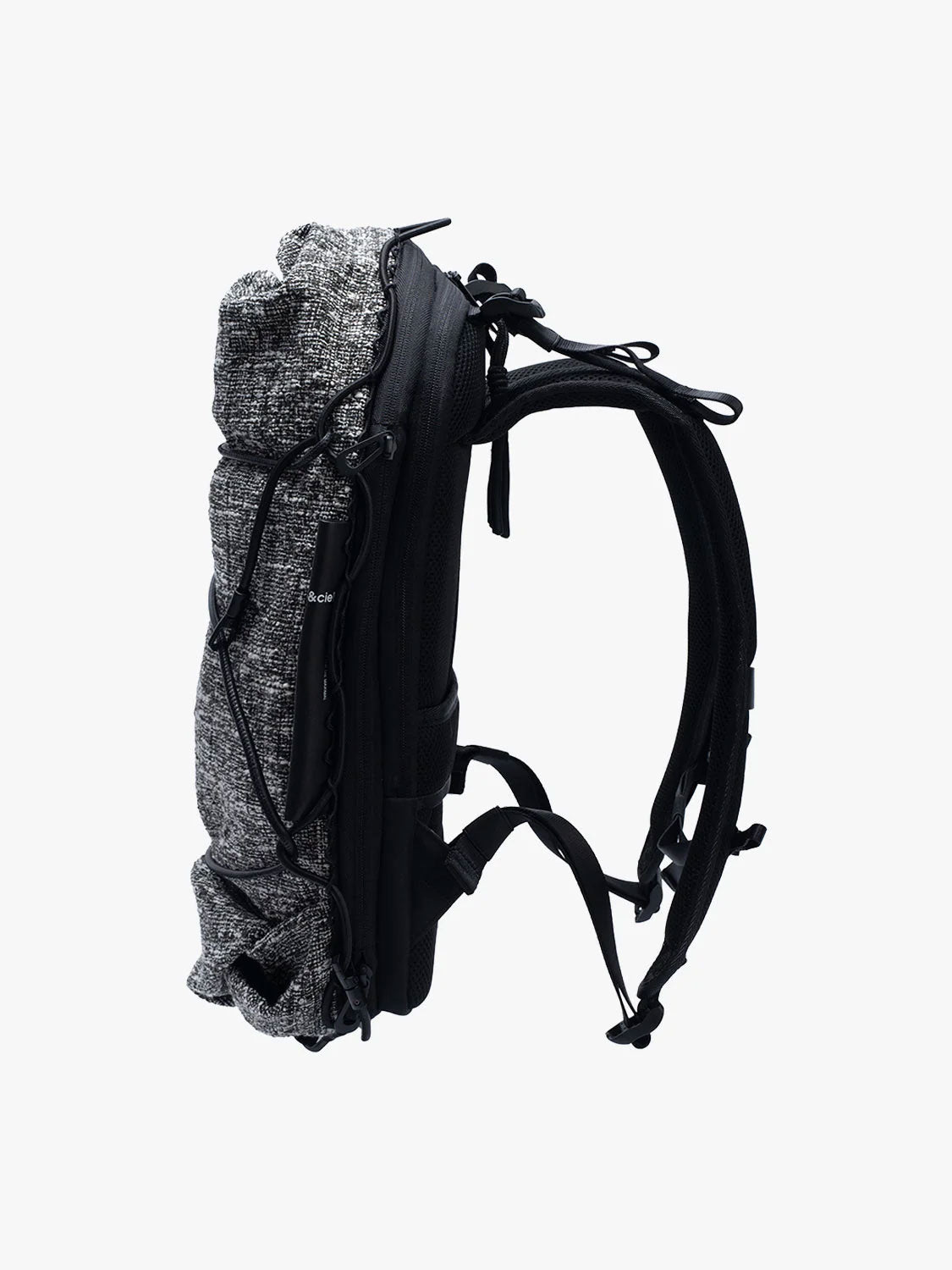 Side view of Côte & Ciel Ladon Tweed in Black & Cream backpack showing slim profile, padded straps and zippered construction