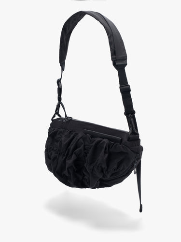 Côte&Ciel Orne Otra Gathered black crossbody bag, back view showing fluid sculptural silhouette and ergonomic shape.