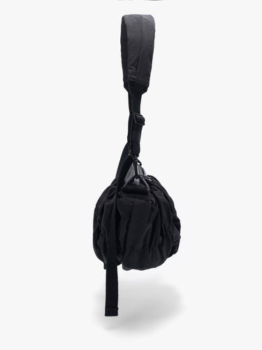 Côte&Ciel Orne Otra Gathered black bag, alternate side view showing ergonomic silhouette and textured nylon folds.
