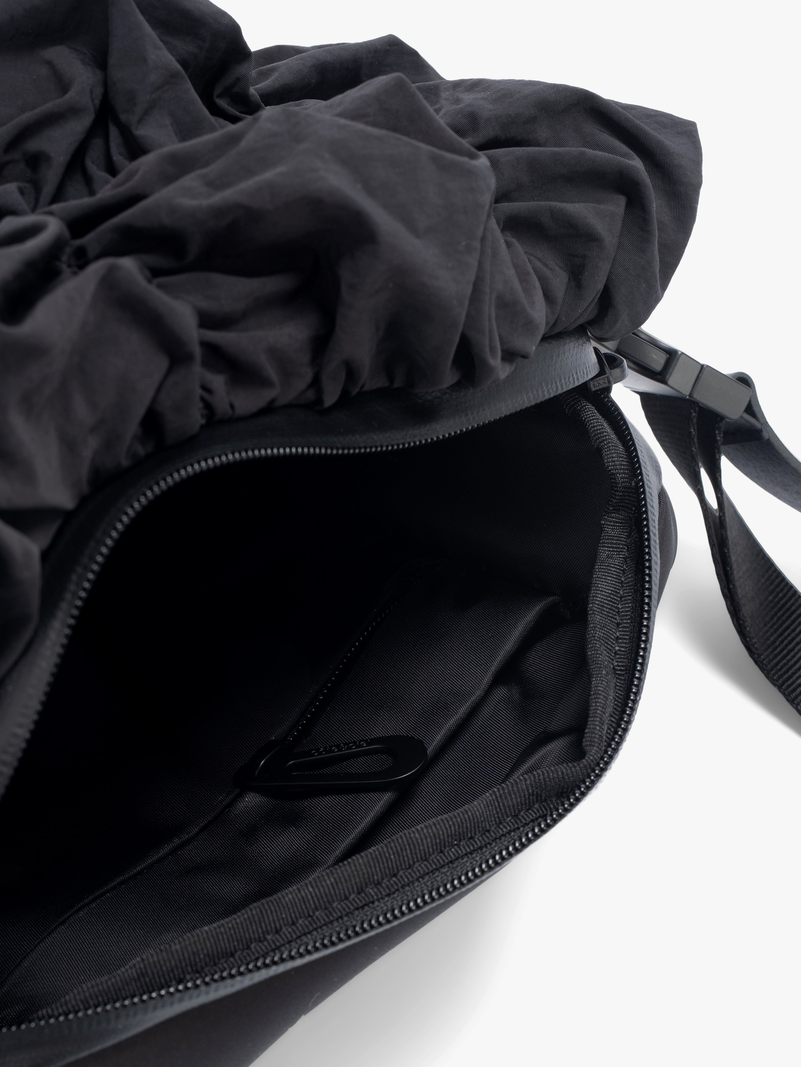 Closeup of Côte&Ciel Neva Gathered black bag, showing water-resistant zipper and secure storage for everyday essentials.