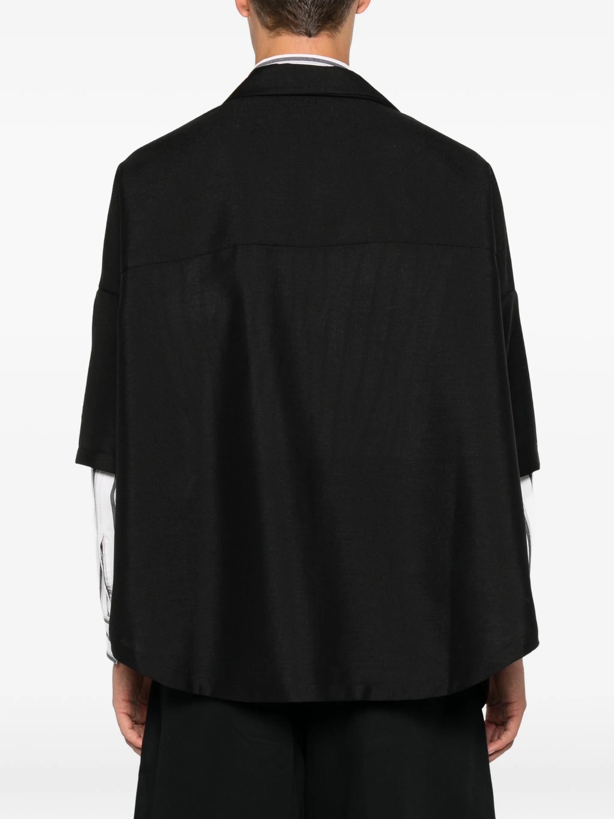 House Of The Very Islands Esra Shirt in Black - back view on model showing distinctive cape-style back and oversized silhouette