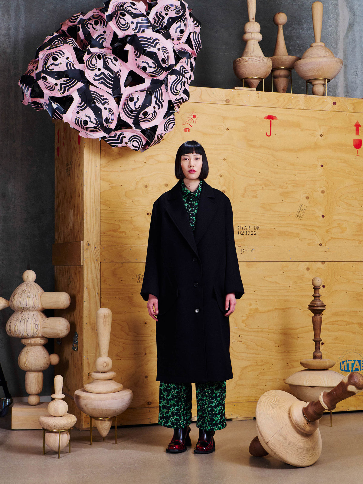 Henrik Vibskov 3D Coat in Black styled on model, showing relaxed longline fit, wide notch lapels and single-breasted front. ID: ARCHIVE-F602