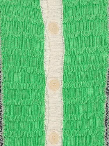 Close-up of the Abundance Cardigan from Henrik Vibskov Spring/Summer 2026 Studio Collection, showing the green, grey, and navy block design with beige details and textured knit around the button closure.