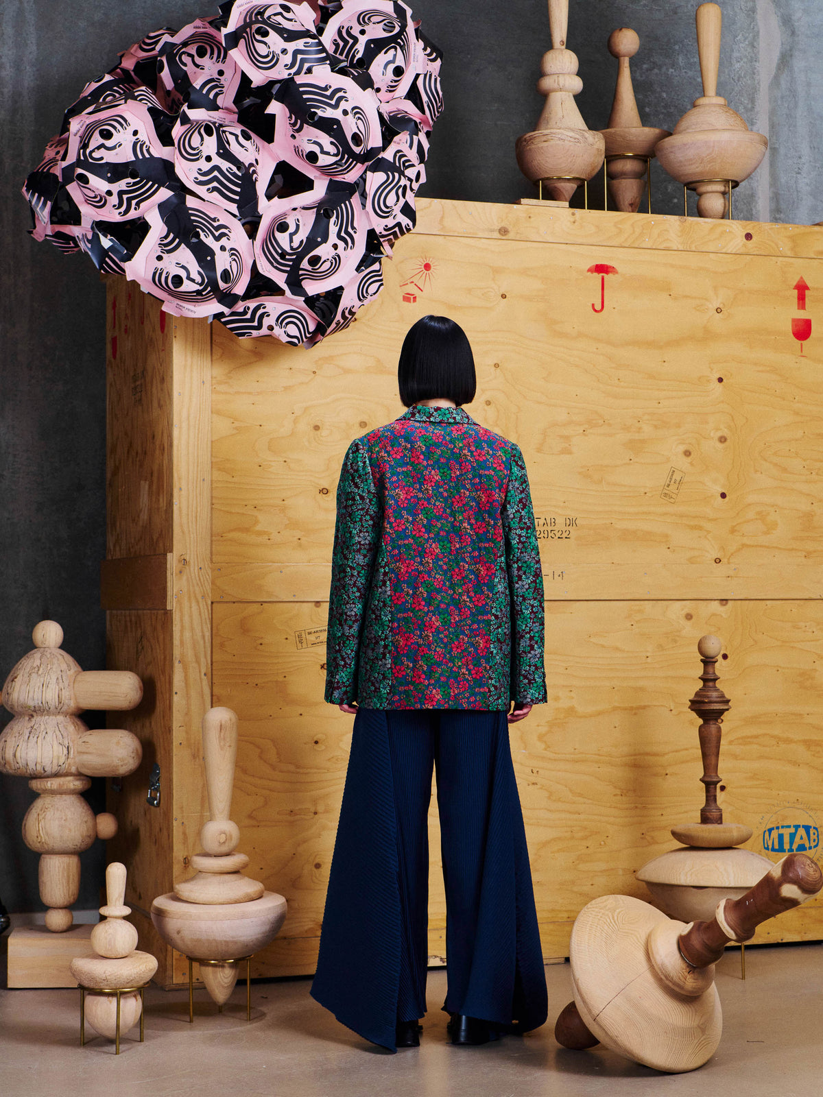Henrik Vibskov Always Blazer in Floral Affairs styled on model from the back, showing straight fit, long sleeves and floral patchwork pattern. ID: ARCHIVE-F612