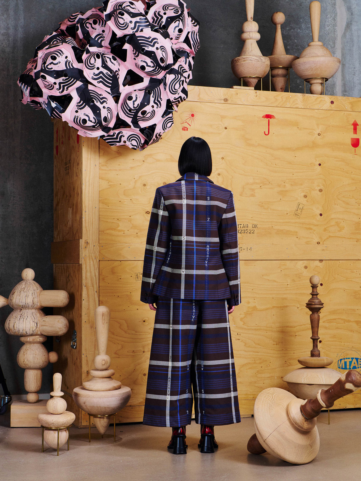 Back view of Henrik Vibskov Always Inside Blazer in Brown Navy Archive with long sleeves, tailored shape and all-over archive check pattern