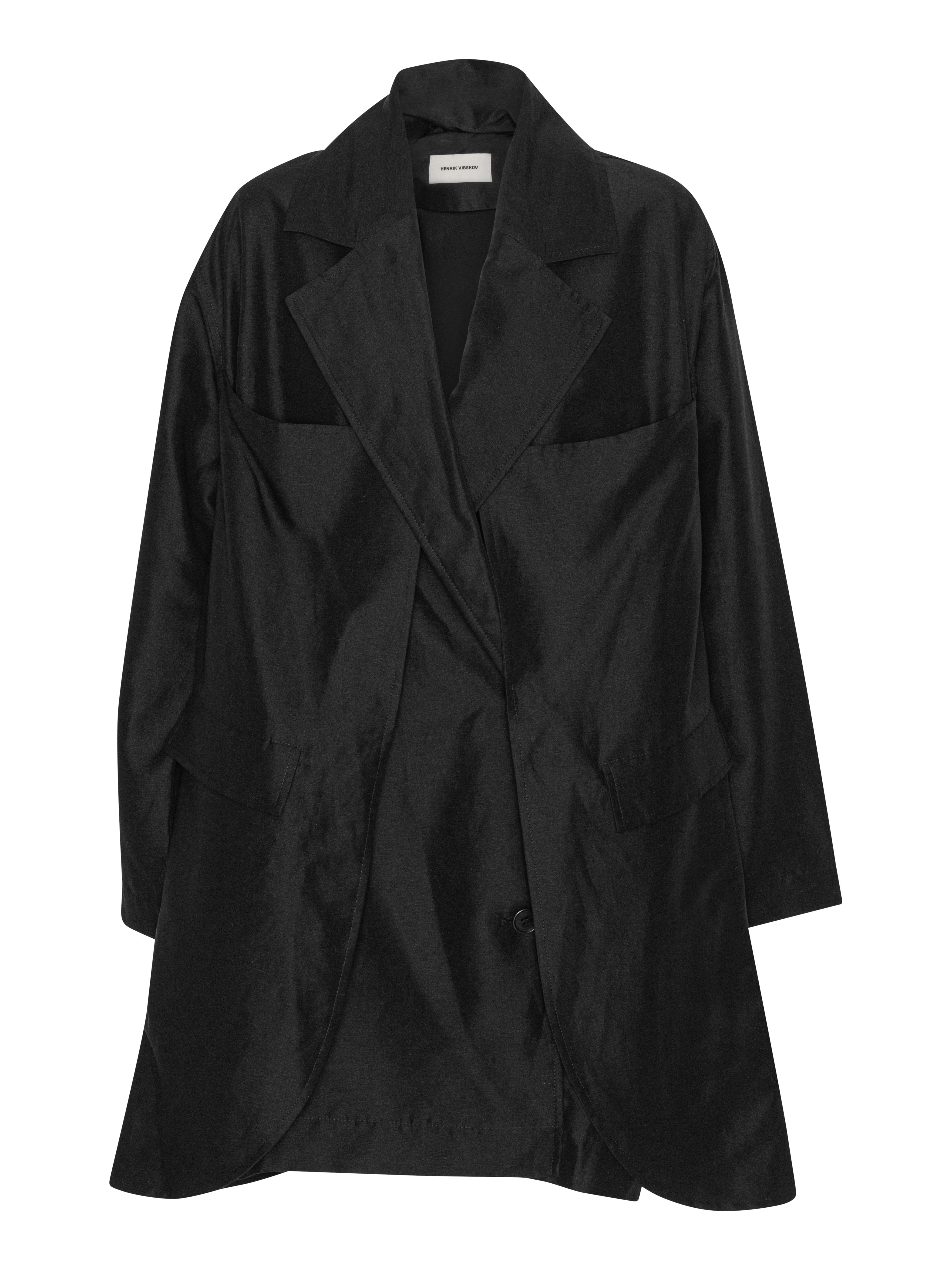 Front view of the Beetle Coat in black Tencel-linen blend, featuring a blazer collar, front button closure, and layered design.