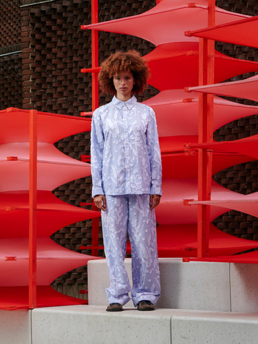 Model wearing the Block Shirt in Crops white and blue striped shirt with embroidered flower details and front button closure, front view – Henrik Vibskov Spring/Summer 2026 Key Collection