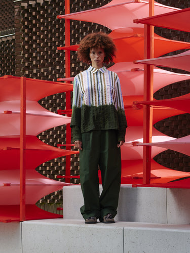 Model wearing Blousse Shirt in DipDye Stripes by Henrik Vibskov, front view of relaxed-fit multicolour striped shirt with dip-dye hem and sleeves, button-front closure and chest pocket, Spring/Summer 2026 Key Collection, model is 176 cm wearing size M