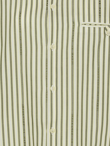 Close-up of the green and beige striped fabric, highlighting layered sleeve detail and button closure.