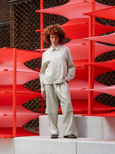 Model wearing the Blousse Shirt in green and beige stripes, shown from the front with relaxed loose fit.