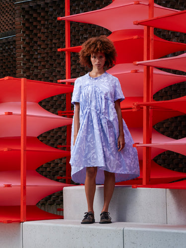 Model wearing Henrik Vibskov Bon Chalant Dress in Crops, shown from the front with oversized fit and sculptural ruched shape.