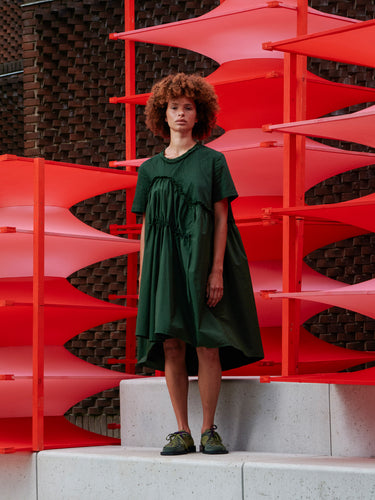 Front view of a model wearing the dark green Bon Chalant Dress with oversized ruched silhouette and short sleeves.
