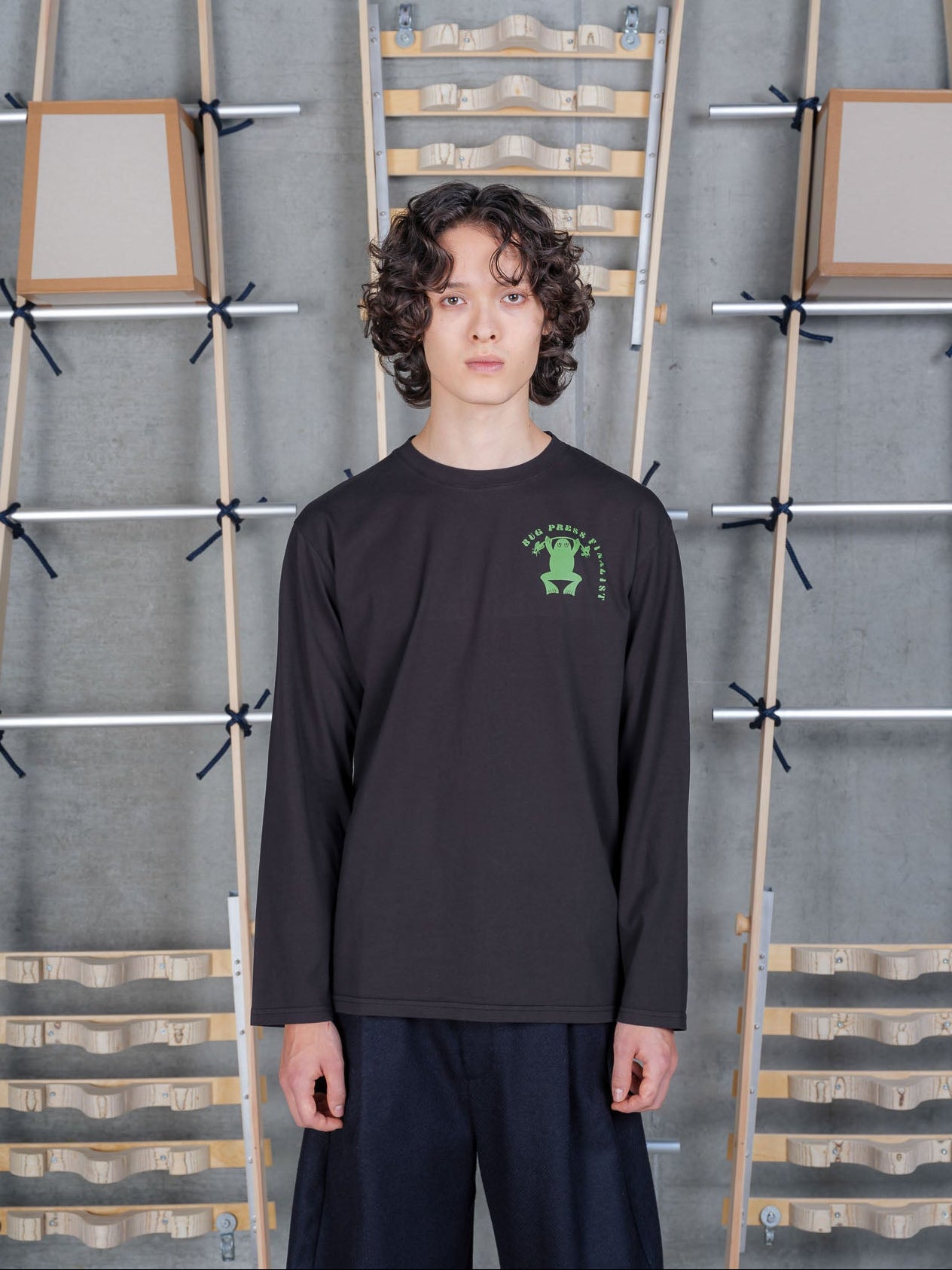 Henrik Vibskov Bug Press Blouse in Black worn on model, full-length front view, green frog graphic chest print, long-sleeve crew neck, relaxed fit