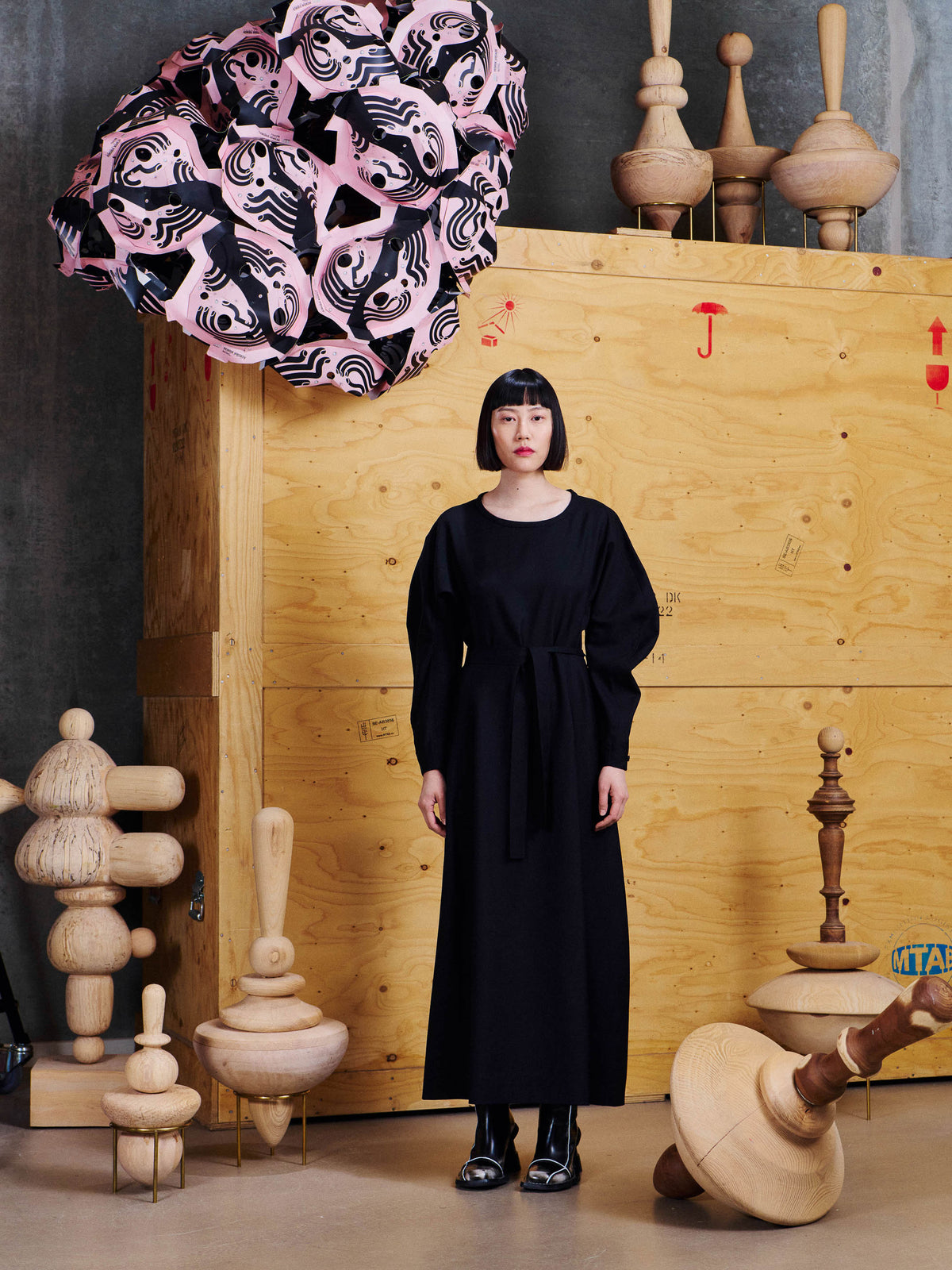 Model wearing the Henrik Vibskov Crackle Dress in Black from the front, showing the long silhouette, waist tie and voluminous sleeves.