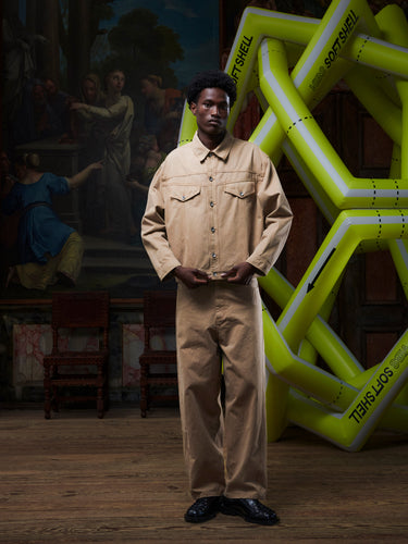 Male model wearing the dark beige Curved Denim Pants from the front, showing the straight-leg fit and classic denim construction. Model is 191cm tall and wears size M.