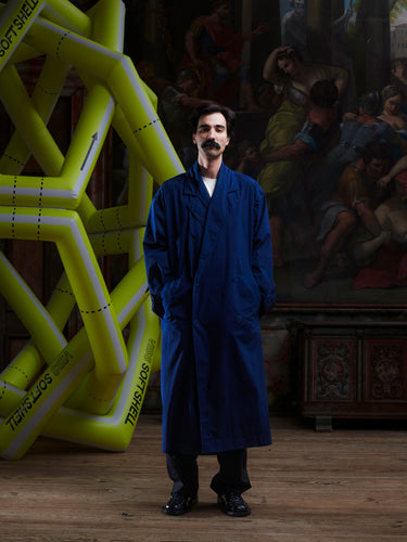 Model wearing the Dimout Long Coat in Navy, front view. Model is 181 cm and wears size M/L, showing the structured blazer collar, double-breasted front, and long tailored fit.