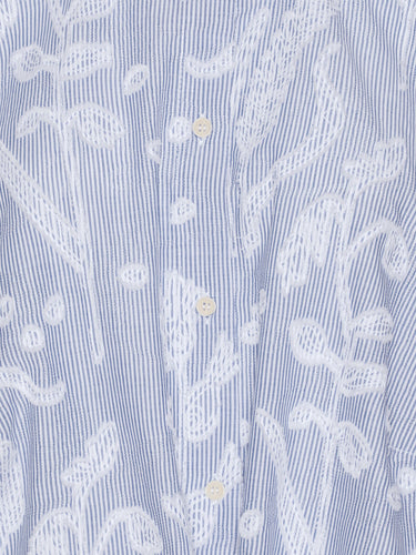 Close-up showing the white distressed flower print, fabric texture, and mandarin collar detail of the Flat Shirt.