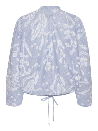 Back view of the Flat Shirt in light blue, highlighting the relaxed fit and elasticated hem.