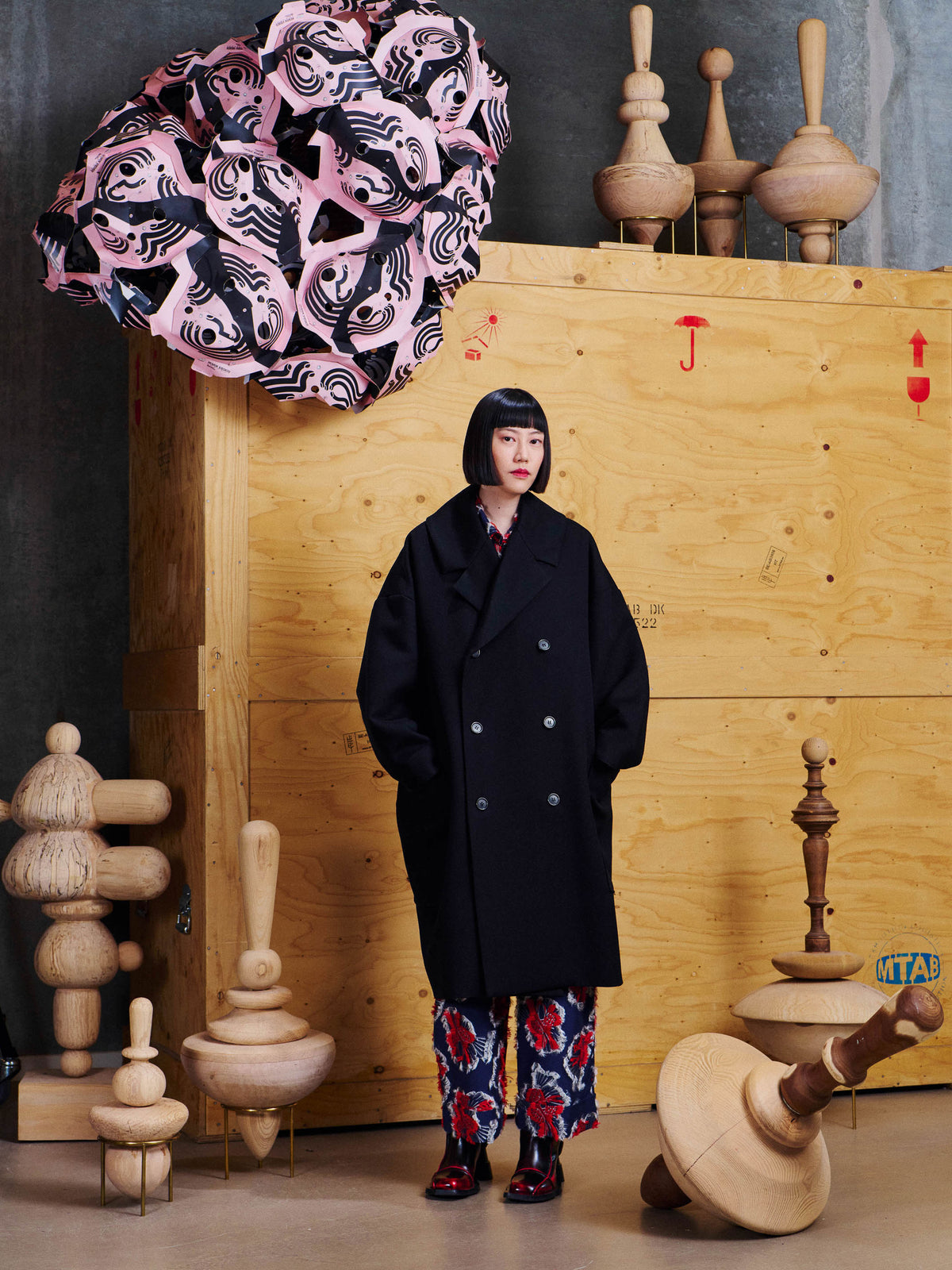 Model wearing the Henrik Vibskov Floating Coat in Black from the front, showing the oversized fit, dropped shoulders and large front pockets.