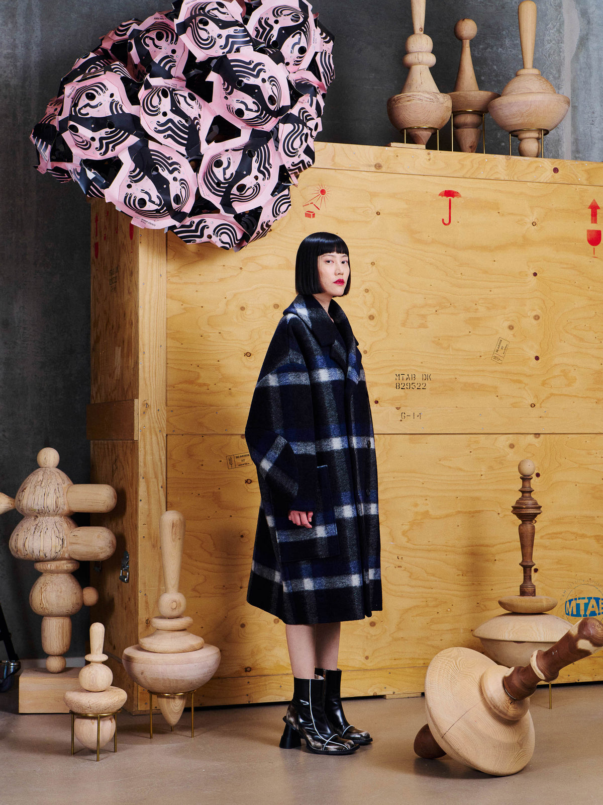 Henrik Vibskov Floating Coat in Dark Blurry Checks worn side view, showing the oversized fit, brushed texture and large front patch pocket.