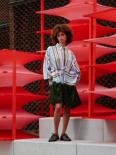 Model wearing Henrik Vibskov Gather Dress in DipDye Stripes, shown from the front with relaxed fit and softly gathered waist.