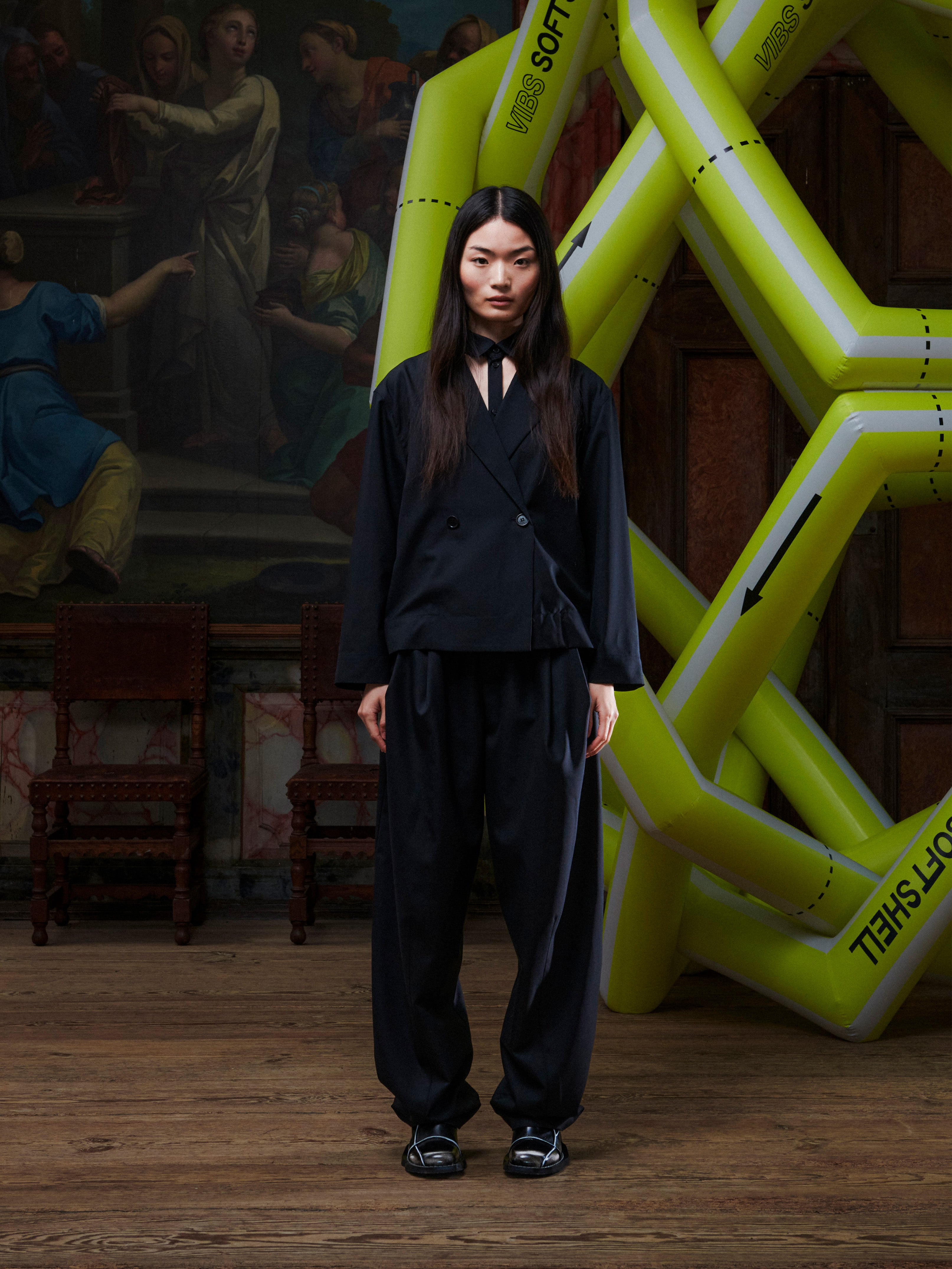 Model wearing the Henrik Vibskov Lonely Sjacket in Tropical Wool, front view. The model is 167 cm and wears size S, showing the layered blazer look, classic collar, and cropped silhouette.