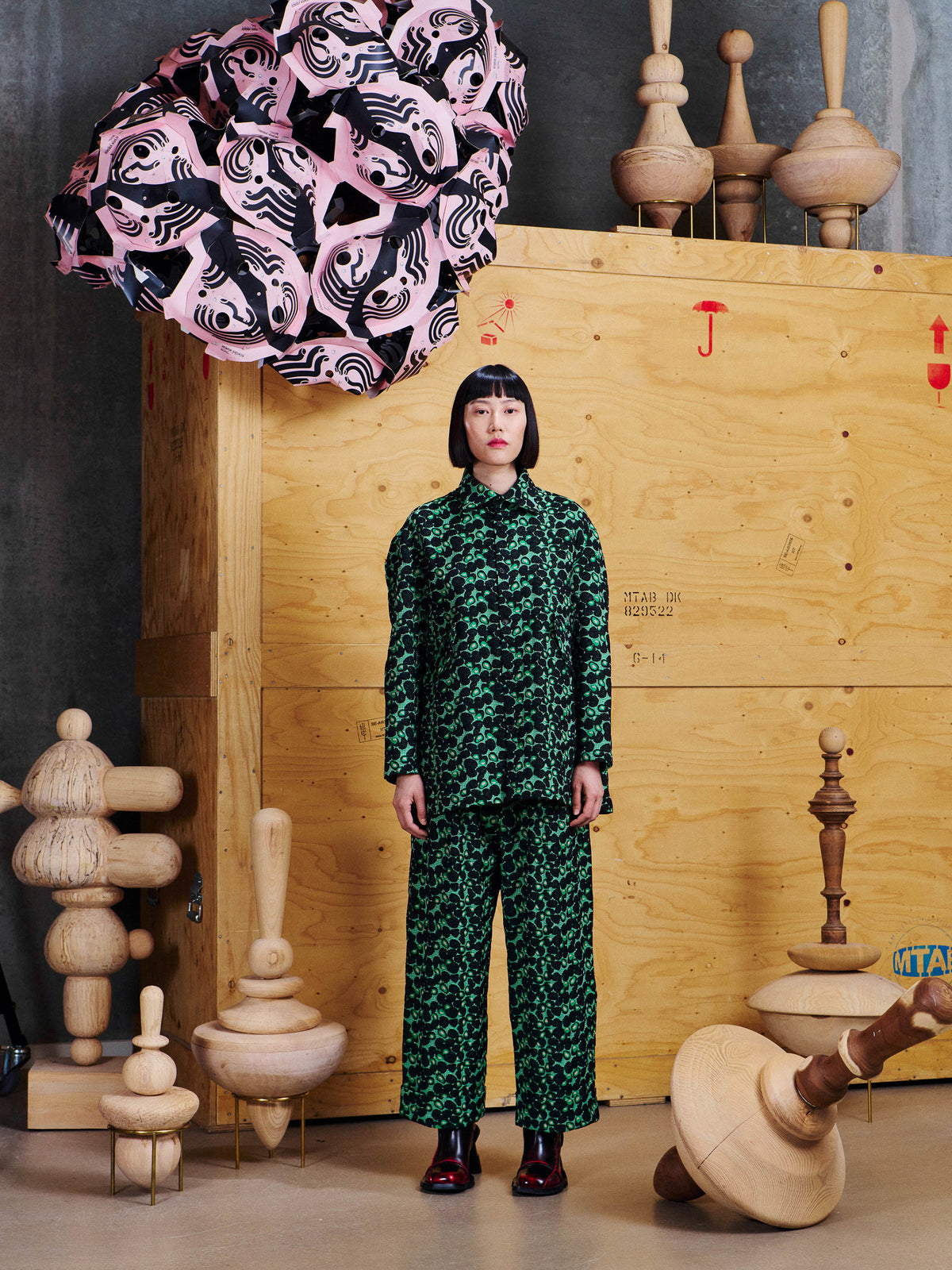 Model wearing the Henrik Vibskov Love You Blouse in Dark Green Berries from the front with matching pants, showing the relaxed fit and textured pattern.