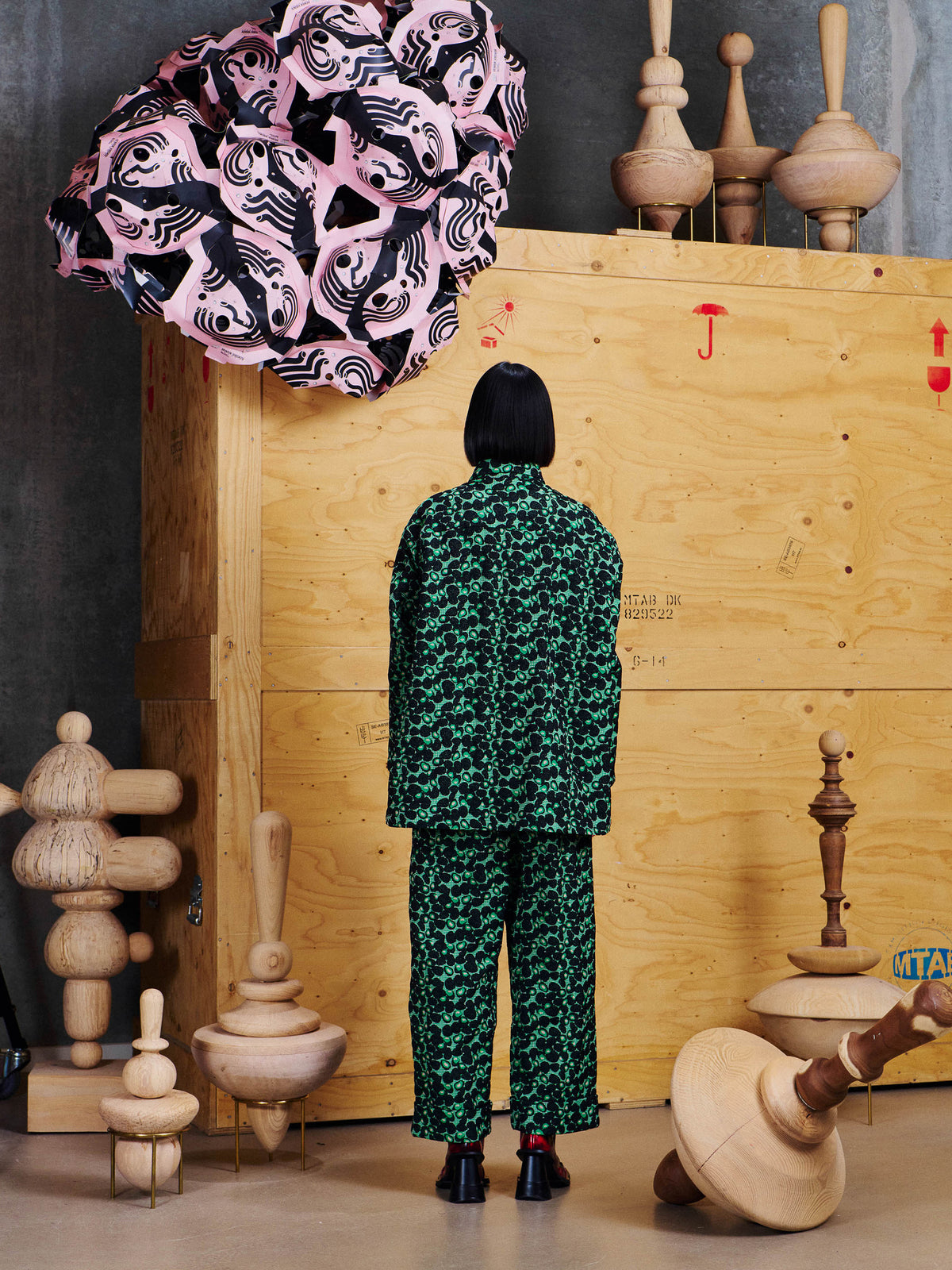 Back view of model wearing the Henrik Vibskov Love You Blouse in Dark Green Berries with matching pants, showing the all-over pattern and straight silhouette.