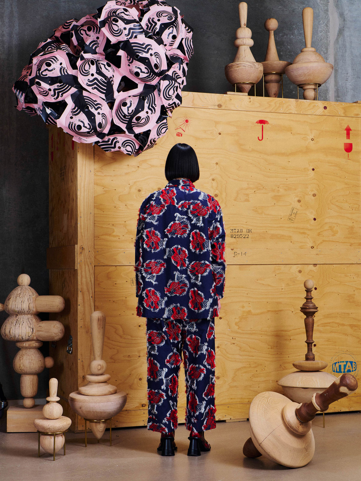 Back view of model wearing the Henrik Vibskov Love You Blouse in Red Navy Birdy with matching trousers, showing the relaxed silhouette and all-over motif.