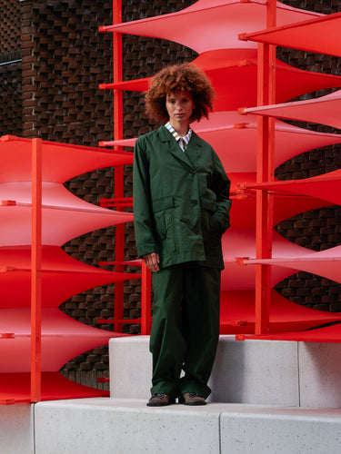 Model wearing the Mid-Air Jacket in Garden Green navy green checked jacket with classic collar and button closure, front view – Henrik Vibskov Spring/Summer 2026 Key Collection