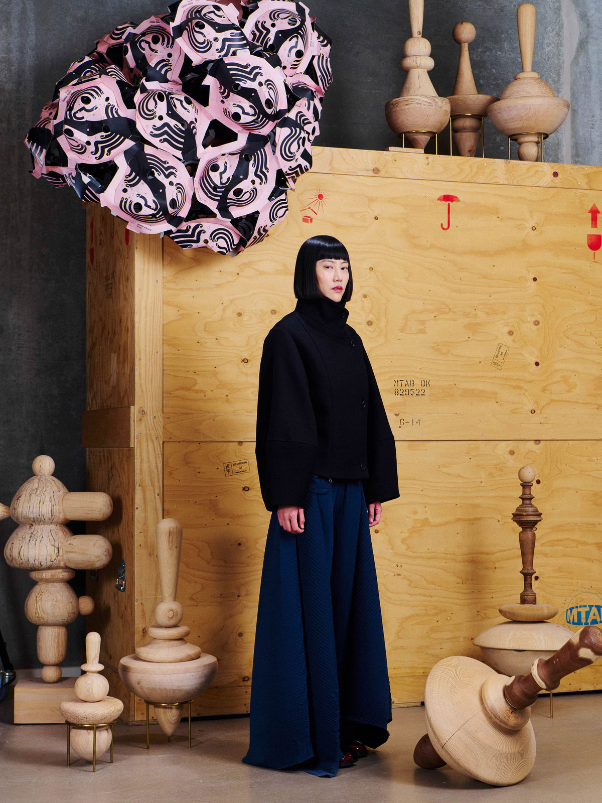 Side view of model wearing the Henrik Vibskov Moon Short Jacket in Black, showing the cropped length, structured shape and wide sleeves.
