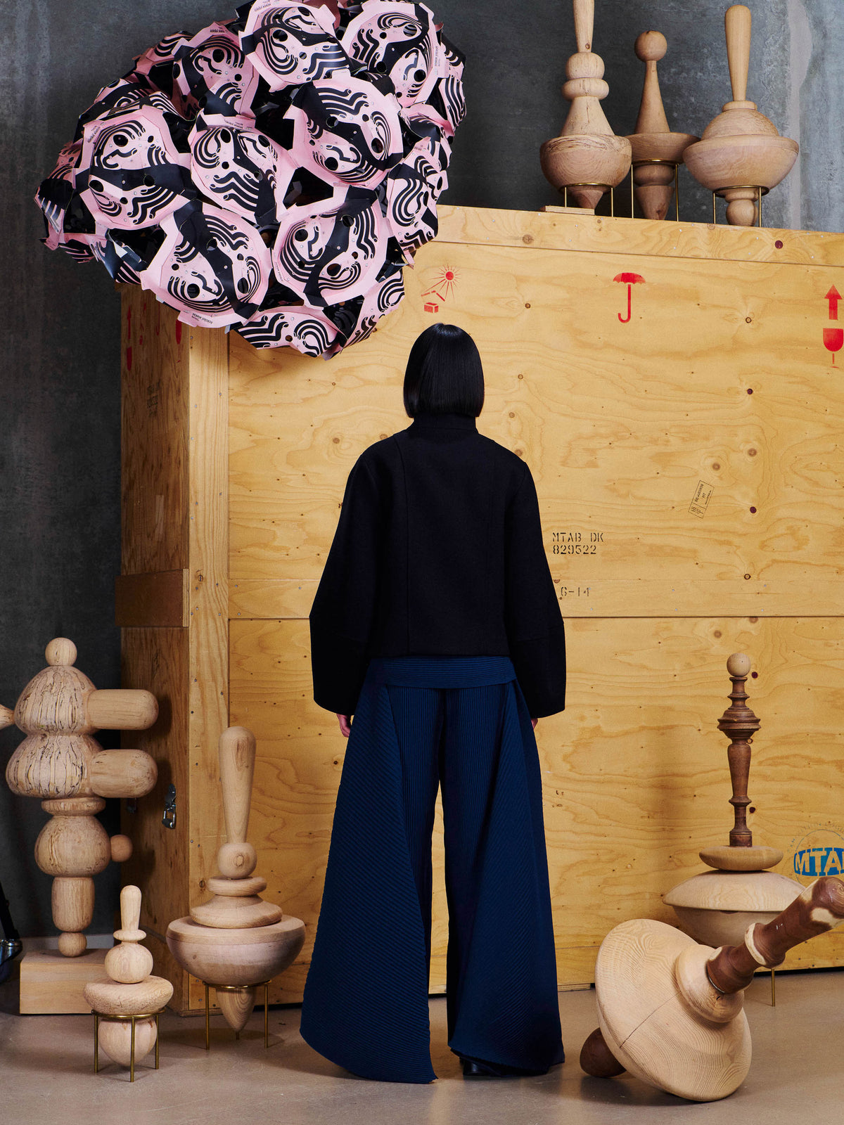 Back view of model wearing the Henrik Vibskov Moon Short Jacket in Black, showing the clean cropped back and wide sleeve silhouette.