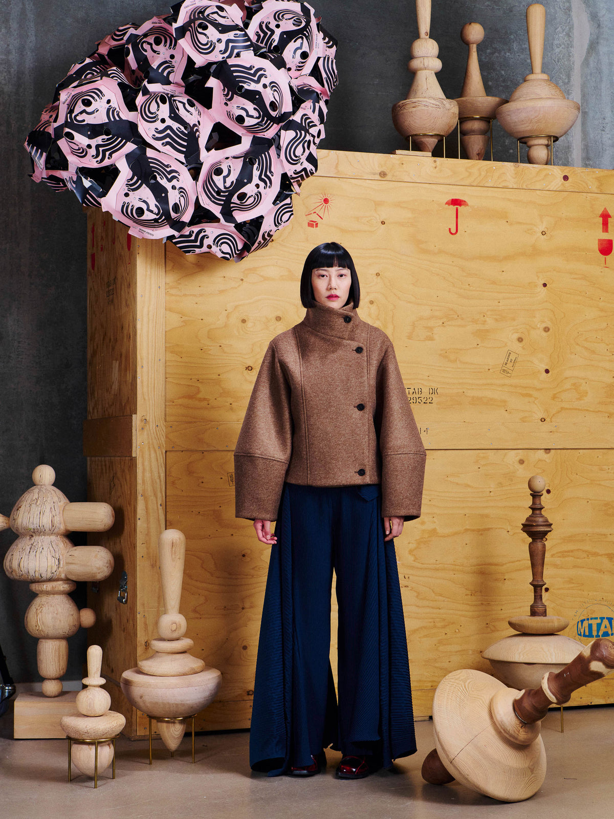 Model wearing the Henrik Vibskov Moon Short Jacket in Camel from the front, showing the cropped silhouette, high collar and wide sleeves.