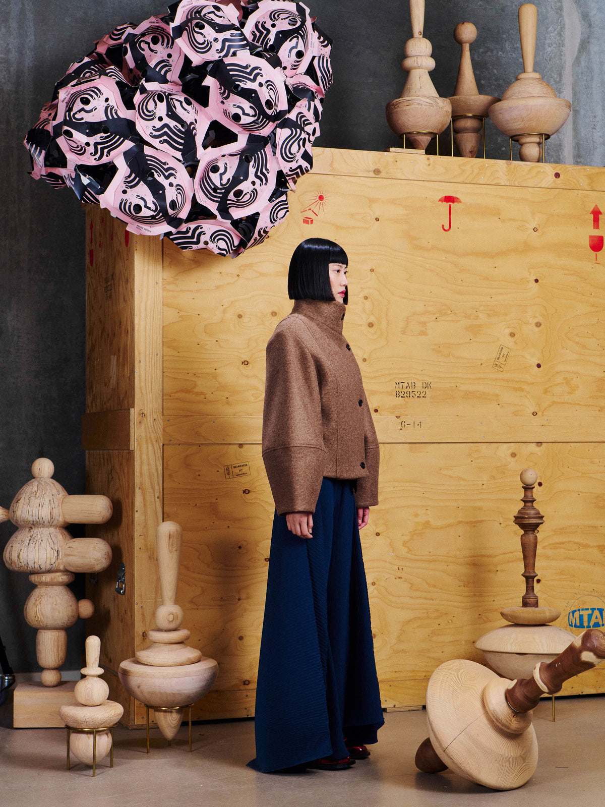 Side view of model wearing the Henrik Vibskov Moon Short Jacket in Camel, showing the cropped length, structured shape and wide sleeves.