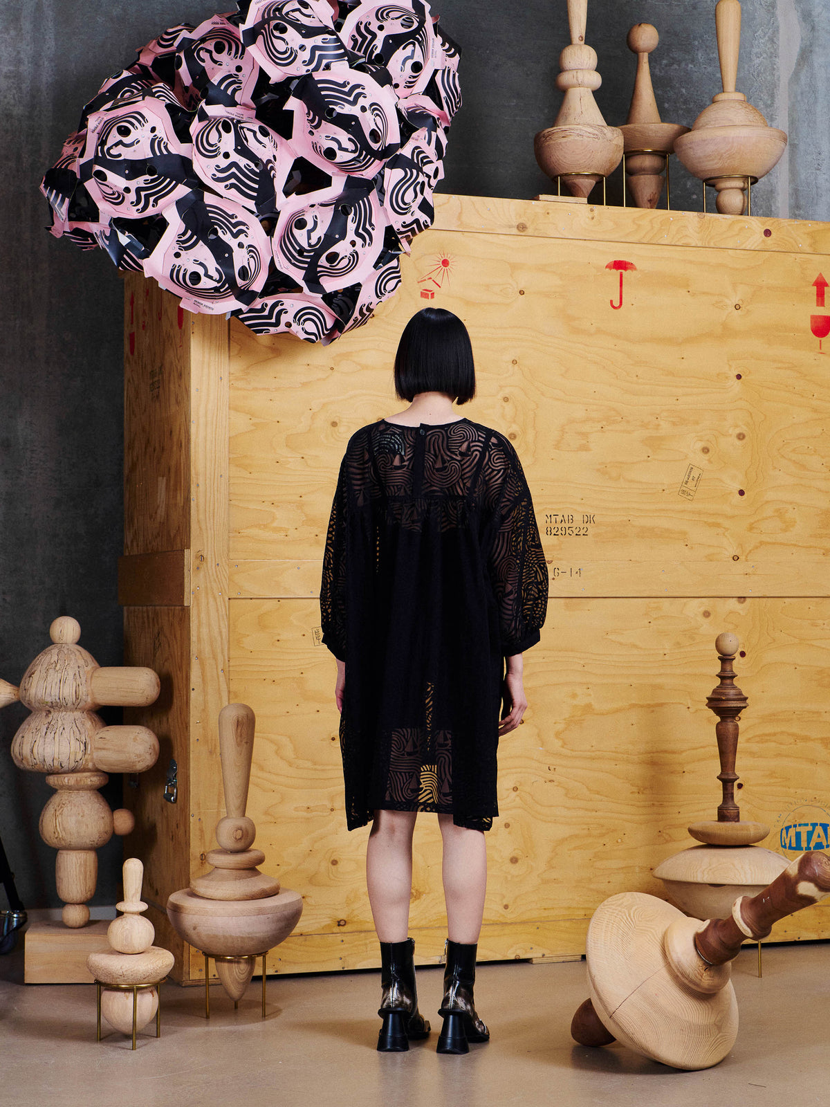 Back view of model wearing the Henrik Vibskov Non Chalant Dress in Dark Stormy Sea, showing the semi-sheer wave pattern and relaxed silhouette.