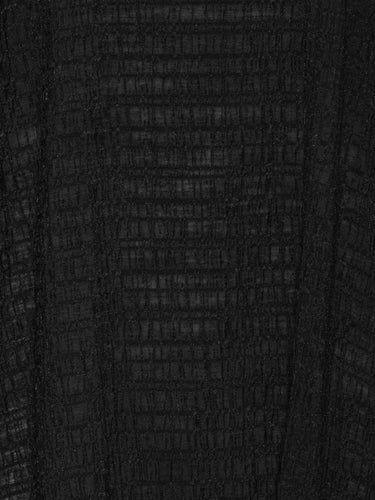 Close-up of checkered pattern and textured fabric detail on the Octo Dress in Black loose-fit dress with curved sleeves – Henrik Vibskov Spring/Summer 2026 Key Collection