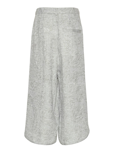 Back view of the Overlap Pants highlighting the wide-leg silhouette and sculptural curved hem.