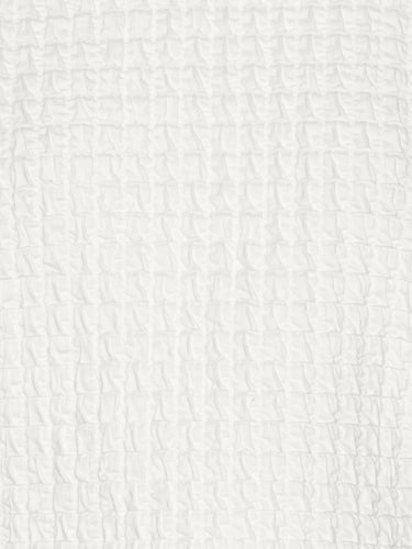 Close-up showing the textured off-white fabric of the Persey Top.