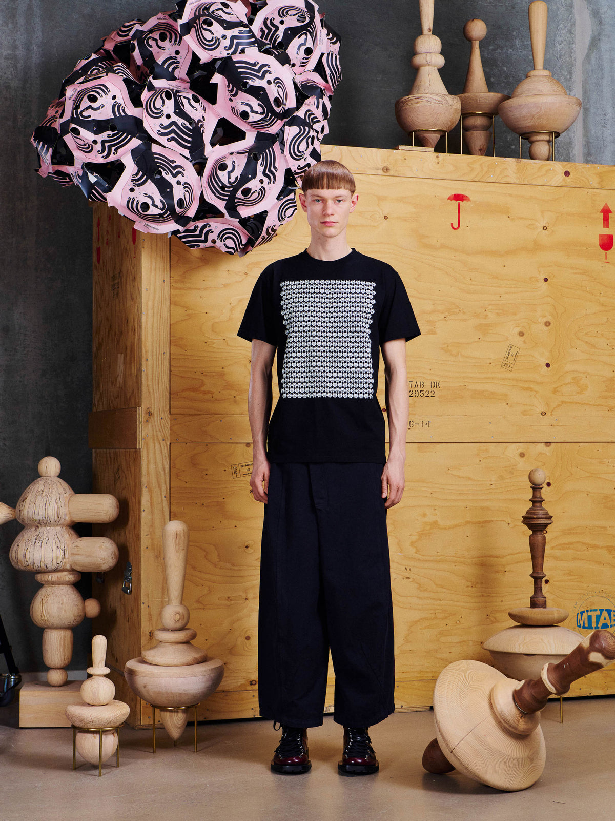 Henrik Vibskov Pig Graduation Tee in Black worn front view, showing the regular fit, short sleeves and large white front graphic.