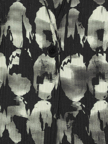 Close-up of the Henrik Vibskov Plissé Blazer in Bursting Eggs, highlighting the abstract egg illustration and pleated plissé texture.