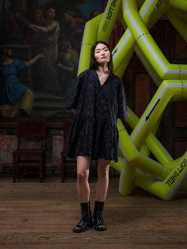 Model wearing the Henrik Vibskov Preserve Blouse in Black Amulets, front view. The model is 167 cm and wears size S, showing the oversized fit, V-neck with button, and wide, knee-length skirt.